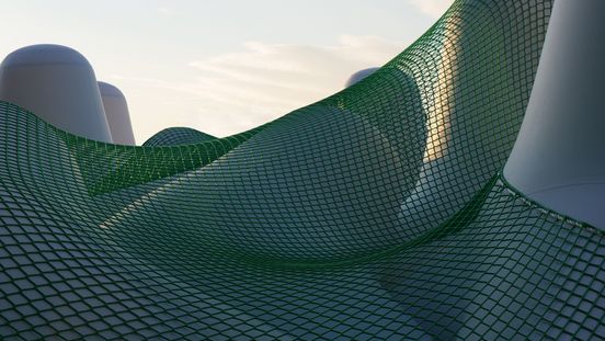 Photo: View of white tetrapods, some of which are connected by a green net.