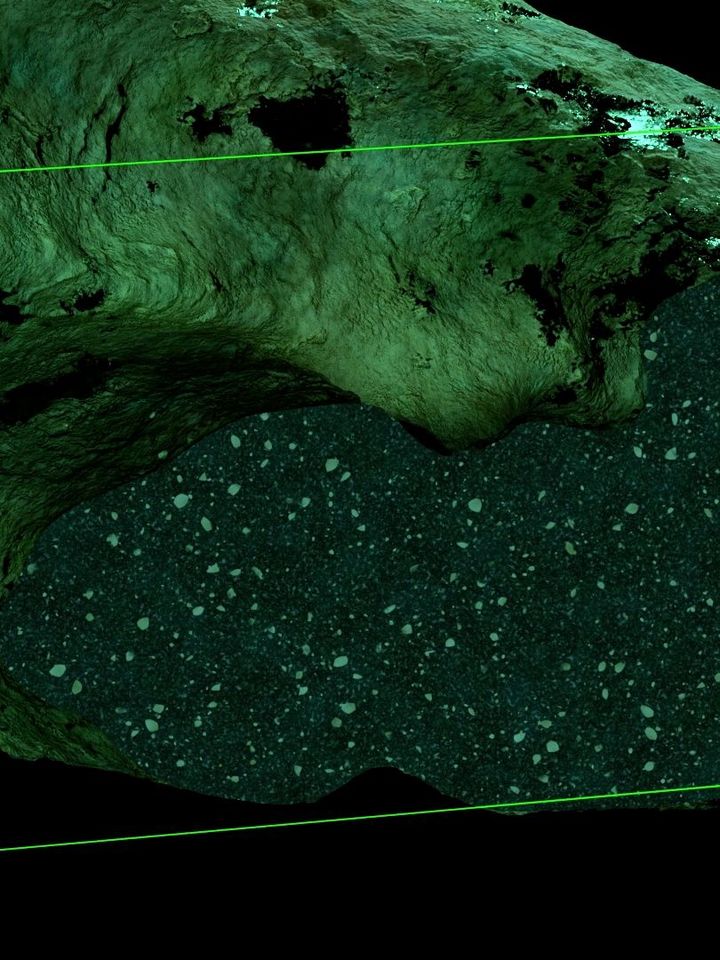 Rock surface in shades of green in which a rectangular area is highlighted with a translucent green frame. The highlighted area shows a dense structure with small, scattered dots that look like rock fragments or sediment particles.