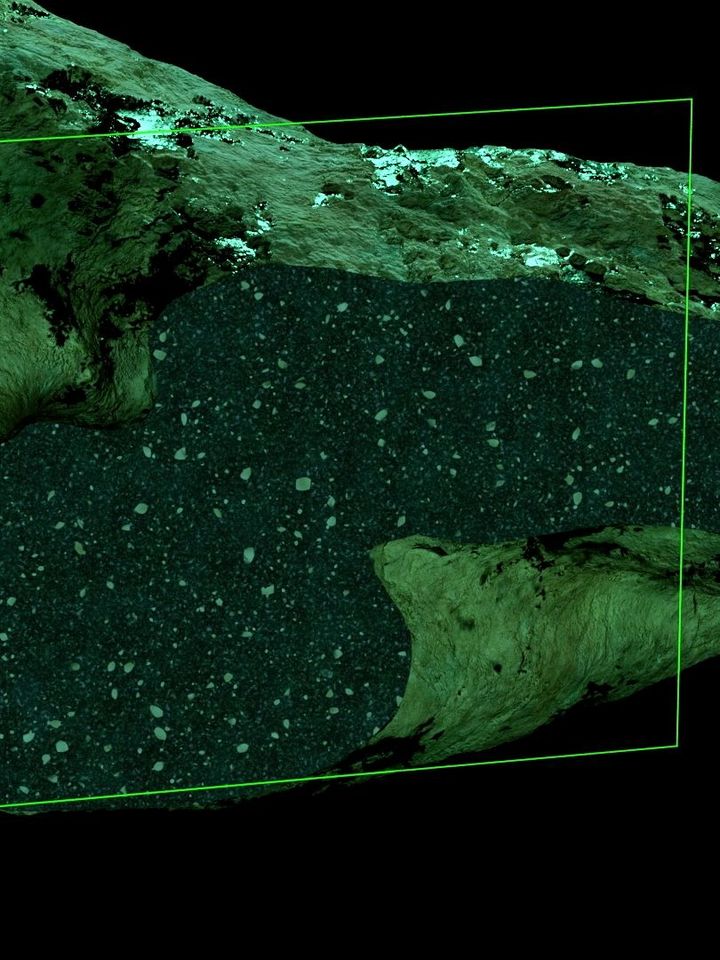 Gesteinsoberfläche in Grüntönen, bei der ein rechteckiger Bereich mit einem durchscheinenden grünen Rahmen hervorgehoben ist. Der hervorgehobene Bereich zeigt eine dichte Struktur mit kleinen, verstreuten Punkten, die wie Gesteinsfragmente oder Sedimentpartikel aussehen.