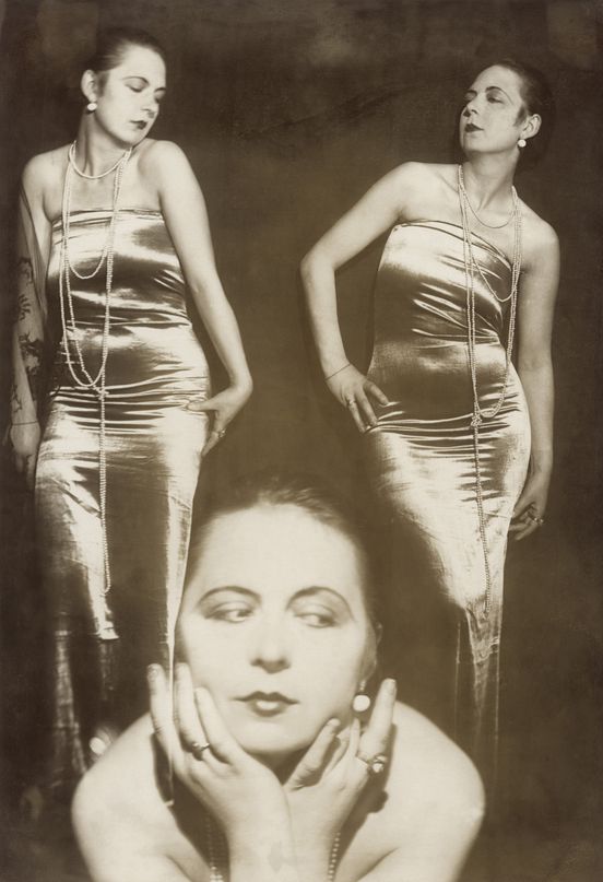 Sepia photograph: The photograph shows the artist in three different poses. She is wearing an elegant satin dress and a long pearl necklace.