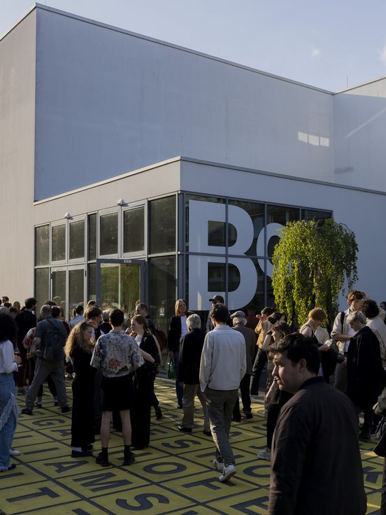 Foto: Blick auf den Vorplatz der Berlinischen Galerie, auf dem viele Menschen in größeren und kleineren Grüppchen zusammen stehen. 