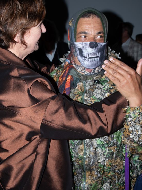 Photo: Marc Brandenburg in camouflage gear, his face half-covered by a kind of scarf with a skeleton pattern.