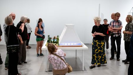Photo: Snapshots of the opening, showing people either inside the exhibition rooms or in the outdoor area of the Berlinische Galerie.