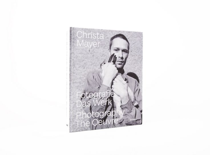 Buchcover mit schwarzweißem Foto einer Person, die ein Kaninchen im Arm hält, mit dem Titel „Christa Mayer – Fotografie Das Werk / Photography The Oeuvre“
