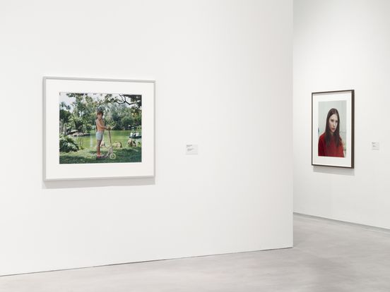 Photo: Two colour photographs by Rineke Dijkstra hang framed on the wall in the exhibition room.