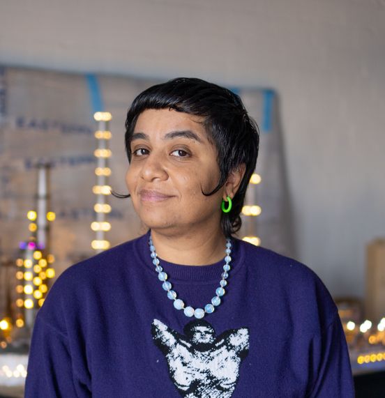 Photo: Portrait of the artist in front of a slightly blurred skyline.