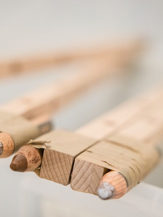 Foto: Nahaufnahme von Stiften, die an Holzstangen gebunden sind und so verlängert wurden.