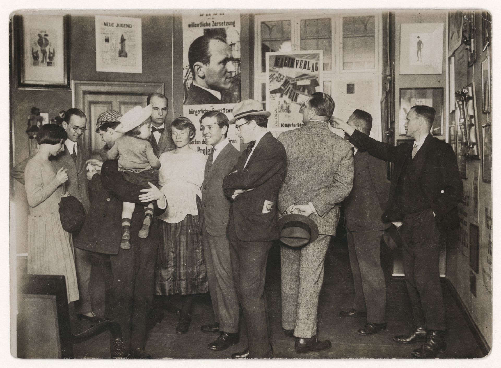 Photograph of the 1. International Dada fair Berlin 1920, [The participants left to right: Hannah Höch, Otto Schmalhausen, Raoul Hausmann, John Heartfield with child, Otto Burchard, Margarete and Wieland Herzfelde, N.N., N.N., Johannes Baader]