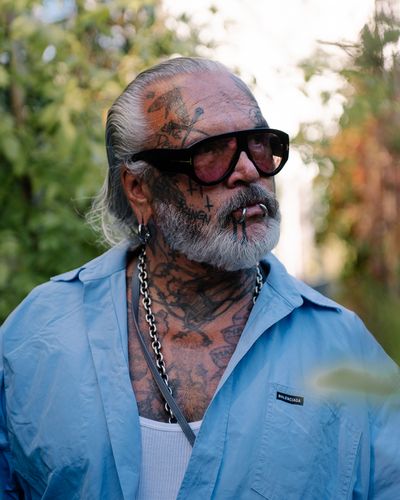 Photo: Scenes from the event, showing people either gathered around a long table with stick-on tattoos, in the foyer or in the outdoor area of the Berlinische Galerie.