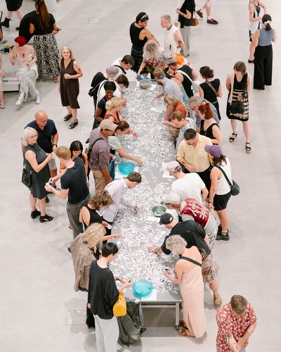 Photo: Snapshots of the event, showing people either gathered round a long table with stick-on tattoos, in the foyer or in the outdoor area of the Berlinische Galerie.